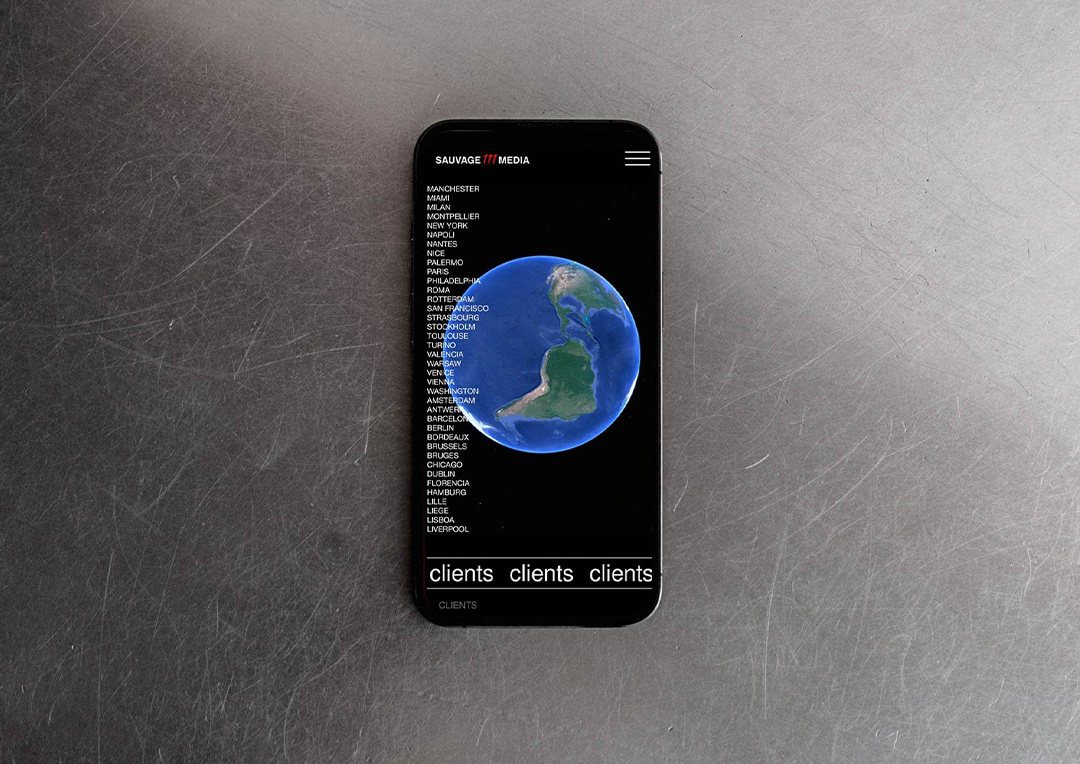 Sauvage Media website on a phone, a globe next to a list of cities